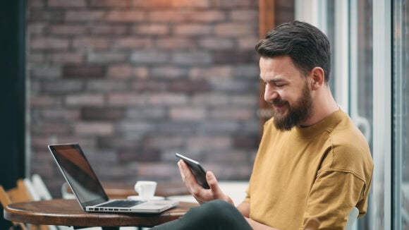 man-on-phone-in-coffee-shop man-on-phone-in-coffee-shop