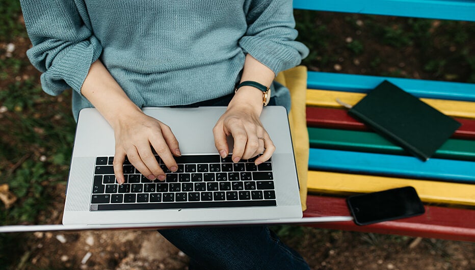 man typing down notes
